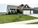 Charming single Gathering home with a two-car garage, well maintained lawn, and inviting front porch at 8755 Stoddard Ln, Indianapolis, IN 46217