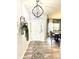 Welcoming foyer featuring stylish decor, a chandelier, and an elegant rug on hardwood floors at 8755 Stoddard Ln, Indianapolis, IN 46217