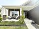 Charming front porch with brick accents, stylish decor, and beautiful landscaping at 8755 Stoddard Ln, Indianapolis, IN 46217