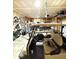 Well-lit garage with a golf cart, utility trailer, and storage solutions, ideal for hobbyists at 8755 Stoddard Ln, Indianapolis, IN 46217