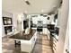 Spacious kitchen boasts white cabinets, stainless steel appliances, and a center island with seating at 8755 Stoddard Ln, Indianapolis, IN 46217
