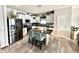 Bright kitchen with stainless steel appliances, a center island, and stylish breakfast bar seating at 8755 Stoddard Ln, Indianapolis, IN 46217