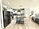 Bright kitchen features stainless steel appliances, center island with seating, and stylish backsplash at 8755 Stoddard Ln, Indianapolis, IN 46217
