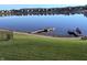 Still lake showcasing several docks with homes along the shore, reflecting in the water at 8755 Stoddard Ln, Indianapolis, IN 46217