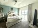 Bright main bedroom with tray ceilings, water views, and balcony access at 8755 Stoddard Ln, Indianapolis, IN 46217