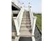 Well-maintained backyard staircase with white railings and black rock landscaping at 8755 Stoddard Ln, Indianapolis, IN 46217