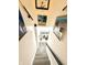 A staircase with woodgrain steps and white walls leading downstairs at 8755 Stoddard Ln, Indianapolis, IN 46217