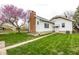 Charming home featuring lush green lawn, mature tree, and white exterior siding at 905 E Yoke St, Indianapolis, IN 46203