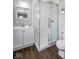 Modern bathroom features a glass shower, updated vanity, tile flooring, and a commode at 905 E Yoke St, Indianapolis, IN 46203