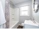 Neutral toned bathroom with single sink vanity and a shower and tub combination at 905 E Yoke St, Indianapolis, IN 46203