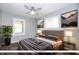 Staged bedroom with neutral colors, multiple windows, and a ceiling fan at 905 E Yoke St, Indianapolis, IN 46203