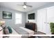 Staged bedroom with neutral gray paint, a ceiling fan and a flat screen television at 905 E Yoke St, Indianapolis, IN 46203