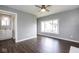 This bedroom has a ceiling fan, nice gray paint, and dark wood-look flooring at 905 E Yoke St, Indianapolis, IN 46203
