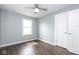 An empty bedroom with laminate wood flooring, a ceiling fan, and white trim at 905 E Yoke St, Indianapolis, IN 46203