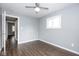 A clean bedroom with laminate flooring, a ceiling fan, and gray walls at 905 E Yoke St, Indianapolis, IN 46203