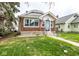 Inviting home with brick accents, a manicured lawn, and a pathway to the front entrance at 905 E Yoke St, Indianapolis, IN 46203