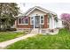Charming brick home with a well-manicured lawn, sidewalk, and an American flag on display at 905 E Yoke St, Indianapolis, IN 46203