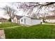Detached one car garage with white siding and green grassy lawn at 905 E Yoke St, Indianapolis, IN 46203
