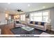 Staged living room with modern furnishings, hardwood floors, recessed lights, and an open layout at 905 E Yoke St, Indianapolis, IN 46203