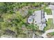 Aerial view of a property with a pristine pool, lush landscaping, and a well-maintained home surrounded by greenery at 961 Starkey Rd, Zionsville, IN 46077