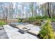 Serene backyard featuring a tiled pool, a cozy fire pit area, and a built-in outdoor grill perfect for relaxation at 961 Starkey Rd, Zionsville, IN 46077