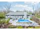 Beautiful backyard with an inviting pool, comfortable lounge seating, and a landscaped patio area great for entertaining at 961 Starkey Rd, Zionsville, IN 46077