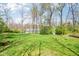 Spacious, lush backyard with mature trees and a glimpse of the home, creating a serene outdoor space at 961 Starkey Rd, Zionsville, IN 46077