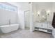 Bright bathroom showcasing a freestanding tub and a vanity with a marble countertop at 961 Starkey Rd, Zionsville, IN 46077