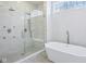 Modern bathroom featuring a glass-enclosed shower with rainfall showerhead and a freestanding bathtub at 961 Starkey Rd, Zionsville, IN 46077