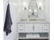 Elegant bathroom vanity with marble countertop, decorative mirror, and modern sconces at 961 Starkey Rd, Zionsville, IN 46077