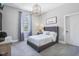 Cozy bedroom with soft lighting, a tufted headboard, and a window overlooking a peaceful setting at 961 Starkey Rd, Zionsville, IN 46077