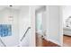 Bright hallway with wood floors leads to a cozy living space and bathroom with a glass door at 961 Starkey Rd, Zionsville, IN 46077