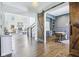 Open-concept living room with hardwood floors, fireplace, and sliding barn door to office at 961 Starkey Rd, Zionsville, IN 46077