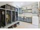 Well-organized mudroom with built-in cubbies, storage, sink, and laundry area at 961 Starkey Rd, Zionsville, IN 46077