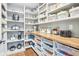 Spacious pantry with custom shelving, wood countertops, and ample storage solutions at 961 Starkey Rd, Zionsville, IN 46077