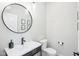 Clean powder room featuring a sleek vanity with a round mirror and modern fixtures at 961 Starkey Rd, Zionsville, IN 46077