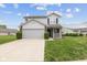 Charming two-story home featuring a well-manicured lawn and attached two-car garage at 9664 Trail Dr, Avon, IN 46123