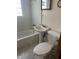 Small bathroom with a tub, toilet, and pedestal sink with chrome faucet at 1105 N Livingston Ave, Indianapolis, IN 46222