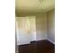 This bedroom has hardwood floors, neutral walls, and a closet with folding doors at 1105 N Livingston Ave, Indianapolis, IN 46222