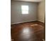 Bedroom with hardwood floors, natural light, and neutral walls at 1105 N Livingston Ave, Indianapolis, IN 46222