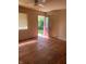 Bedroom with hardwood floors, natural light, and an exterior door at 1105 N Livingston Ave, Indianapolis, IN 46222