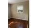 Bedroom featuring hardwood floors, neutral walls, and a window at 1105 N Livingston Ave, Indianapolis, IN 46222