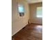 Bedroom with hardwood floors, neutral walls, and natural light from two windows at 1105 N Livingston Ave, Indianapolis, IN 46222