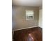 Bedroom features hardwood floors, a window, and neutral walls at 1105 N Livingston Ave, Indianapolis, IN 46222
