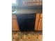Black dishwasher with wooden cabinetry and a unique, patterned countertop at 1105 N Livingston Ave, Indianapolis, IN 46222