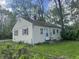 View of a single-story home's exterior with red shutters and a well-kept lawn at 1105 N Livingston Ave, Indianapolis, IN 46222