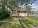 Cozy single-story home with a red front door, red window shutters, surrounded by mature trees at 1105 N Livingston Ave, Indianapolis, IN 46222