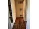 Hallway featuring hardwood floors, built-in shelving, and access to other rooms at 1105 N Livingston Ave, Indianapolis, IN 46222