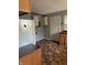 Kitchen with tile floors, white refrigerator, wood cabinets, and gray walls at 1105 N Livingston Ave, Indianapolis, IN 46222