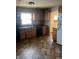 Kitchen area with wooden cabinets, black appliances, patterned flooring, and ample natural light at 1105 N Livingston Ave, Indianapolis, IN 46222